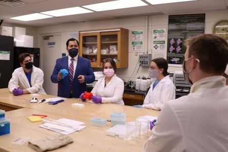 Professor Patil and students sit and work in the NanoBio Lab.