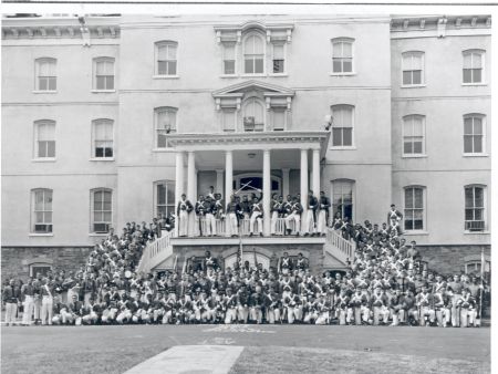 Members of the last cadet class pose for a photo on front steps of Old Main