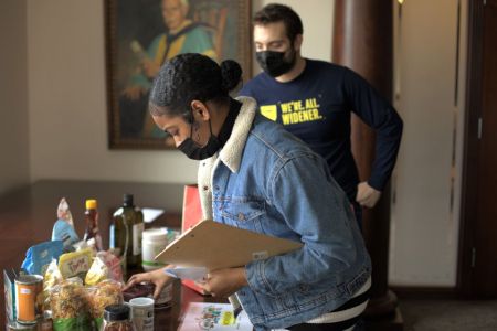 A female student shops for grocery items with supervision from a graduate student during the Independent Living Skills Workshop
