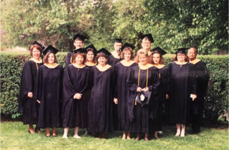 members of the first class of MSW graduates in their caps and gowns