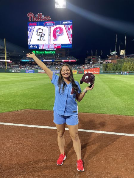 Assistant Coach MacKenzie Lewis in Phillies Ballgirl uniform stands on the field at Citizens Bank Park