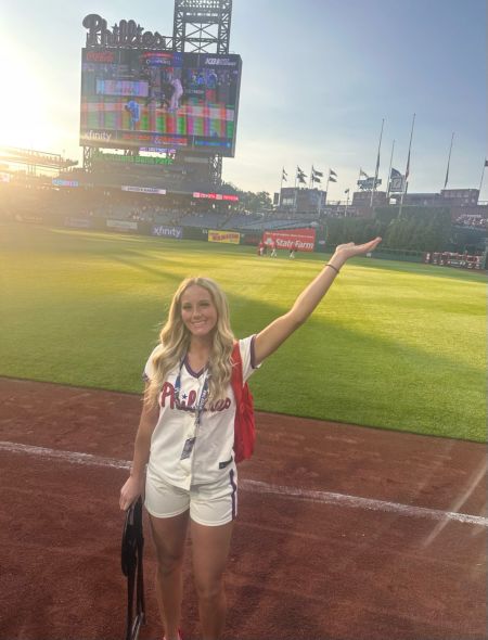 Nursing student Sammy McCarthy in Phillies Ballgirl uniform on the field at Citizens Bank Park
