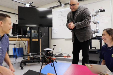 Sky Walker drone 960x640 Daniel Roozbahani, Ethan Matlack, and Dimple Gandevia work with their drone on the landing pad