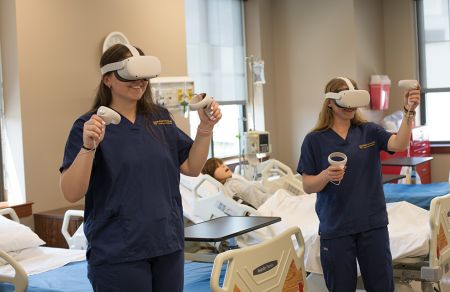 Nursing students sim lab oculus vr 960 x 640 Female nursing students wear oculus headsets to practice in virtual simulated clinical settings.