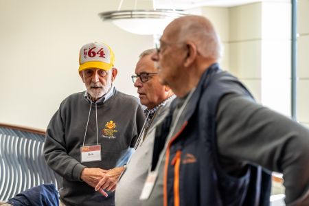 Bob Duffy wearing a PMC Class of '64 hat with fellow alumni