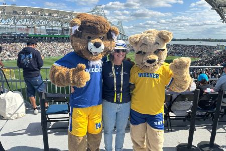 Chester, President Stacey Robertson, and Melrose pose at the Philadelphia Union soccer stadium.