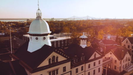 An overhead shot of Old Main with the sun setting in the distance