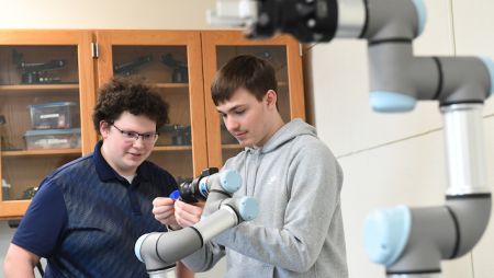 Widener robotics students work on a robot, demonstrating hands-on learning and innovation.