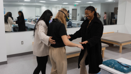 OT Student completing simulation with help of instructors