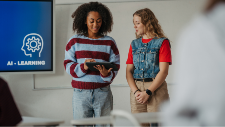 Students collaborating on an artificial intelligence presentation, demonstrating the hands-on learning experiences that show why an AI degree is worth it.