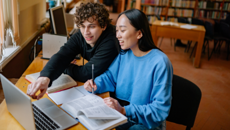 students majoring in AI at widener work on computer in library near philadelphia