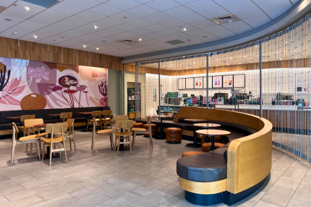 Seating area of campus Starbucks with gate pulled down against the order counter