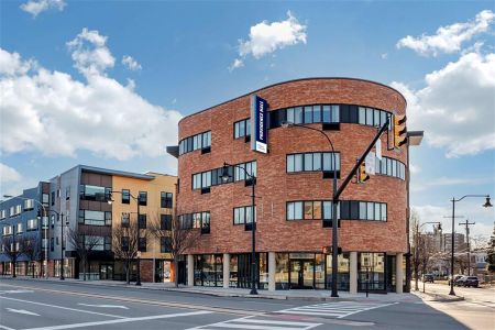 Exterior of Providence Hall, a multi-floor brick building on the corner of two roads