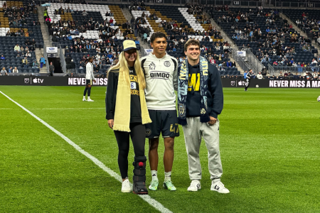 Students Mackenzie Cahall and Tyler Grose pose with a Philadelphia Union II player.