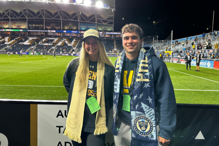 Mackenzie Cahall and Tyler Grose pose for a photo on the sidelines of Subaru Park.