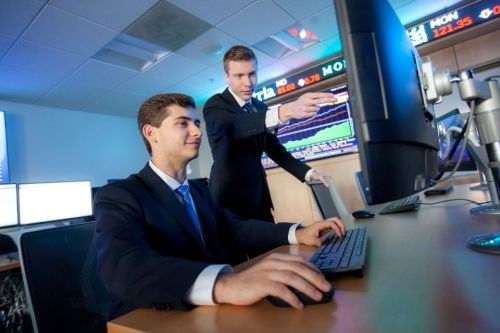 Two students on a computer in the Finance Lab
