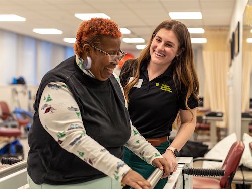 physical therapy student helps client at chester community clinic