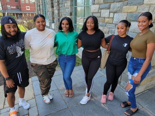 Widener Partnership Charter School students turned Widener graduates stand in a row.
