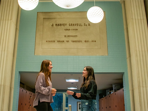 Two students talking in the lobby of Kapelski Learning Center
