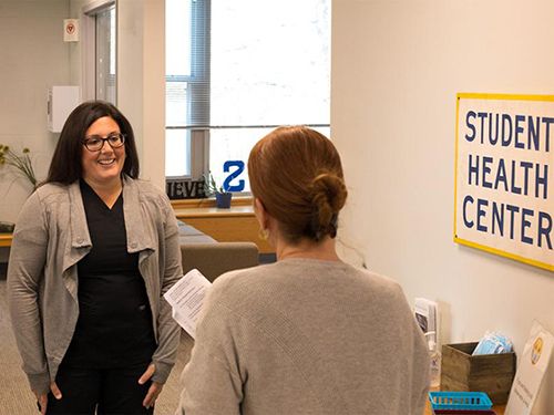 Two people talking in the Student Health Center