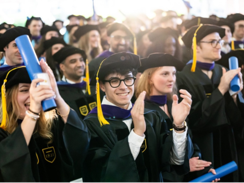 Graduates smile during their commencement ceremony
