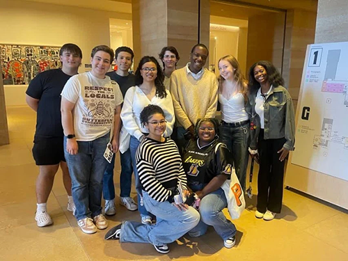 Group of students pose for a photo in a museum