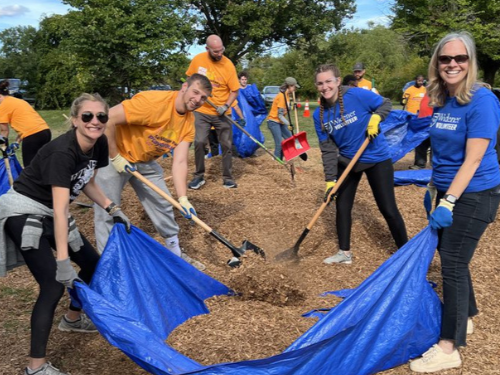 Stacey Robertson building a playground on 9th St in Sun Village alongside PT and OT students