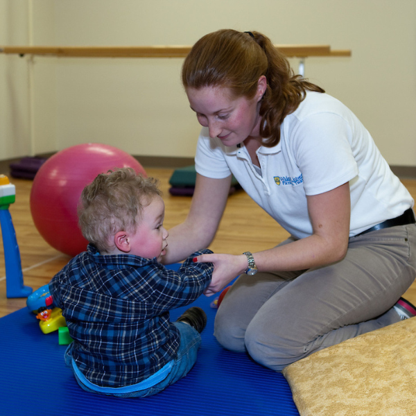 Physical therapy student works with young client.