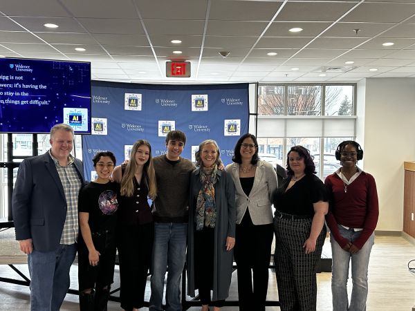 The presenters from AI Sparks event pose together for a photo in front of the stage and Widener AI Week backdrop