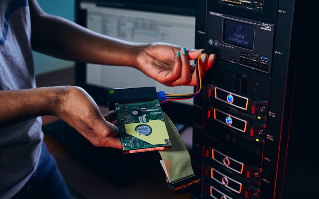 Computer science student with computer chip in lab