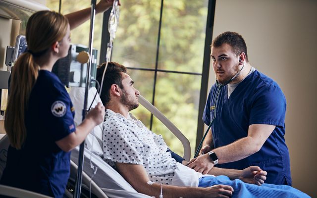 Nursing students caring for patient