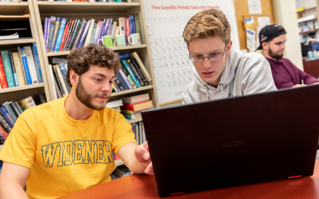 Two students looking at laptop in Widener's tutoring center