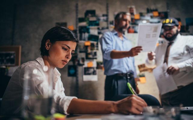 A group of criminal justice professionals going over paperwork. 