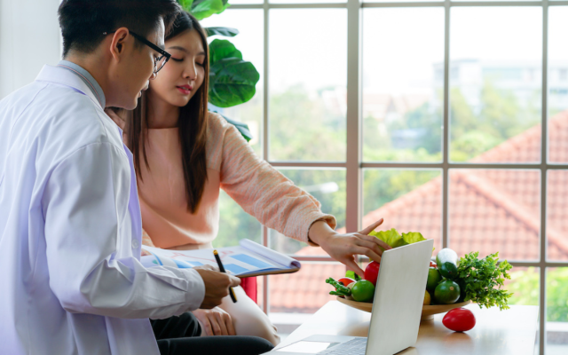 Dietician helps patient plan a nutritious diet.