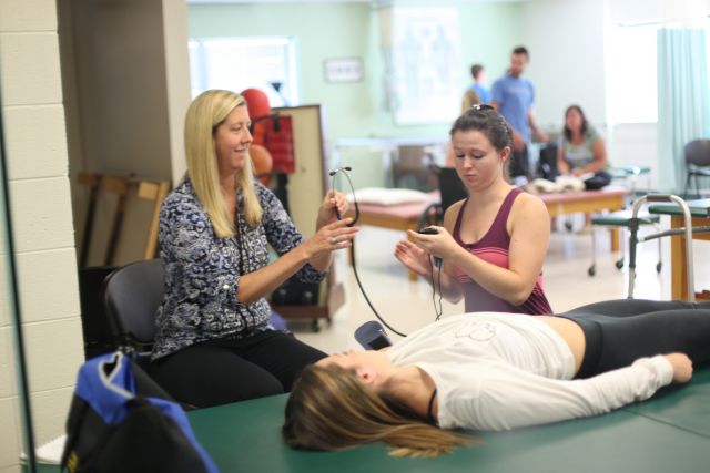 Widener University physical therapy students in class with faculty mentor.