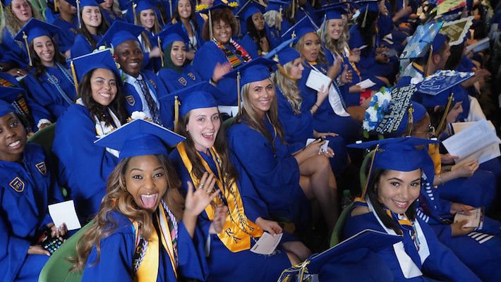students celebrate commencement at mann center
