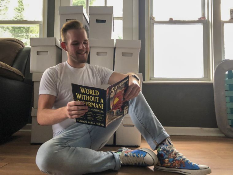 Student Evan Davis reading a Superman comic book