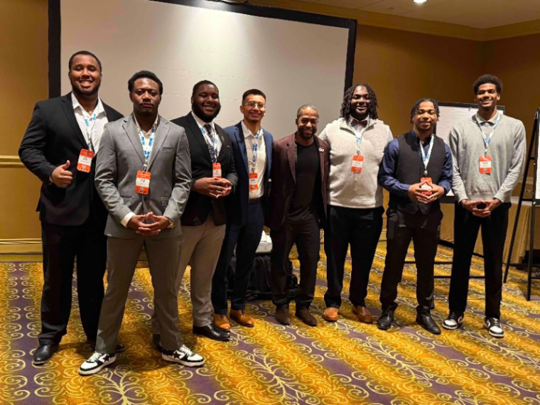 Justin Mack and other conference attendees pose for a photo