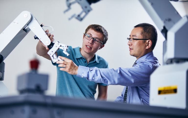 Student and Professor with Robotic Arm