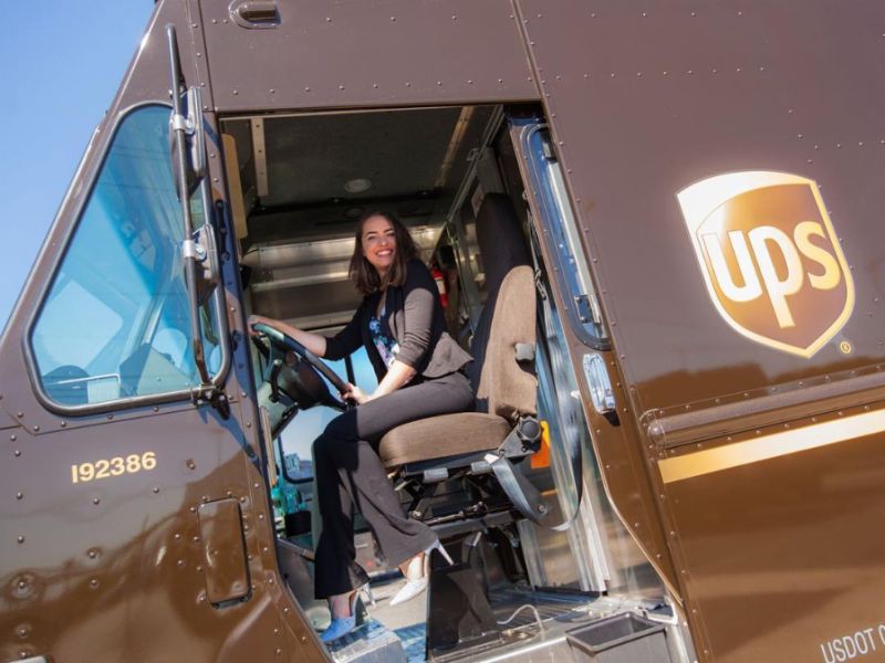 Aly Horton sitting in the driver's seat of a UPS truck