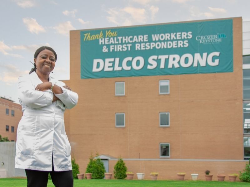 Monjama Korngor poses outside of the Chester-Crozer Medical Center building where she works.
