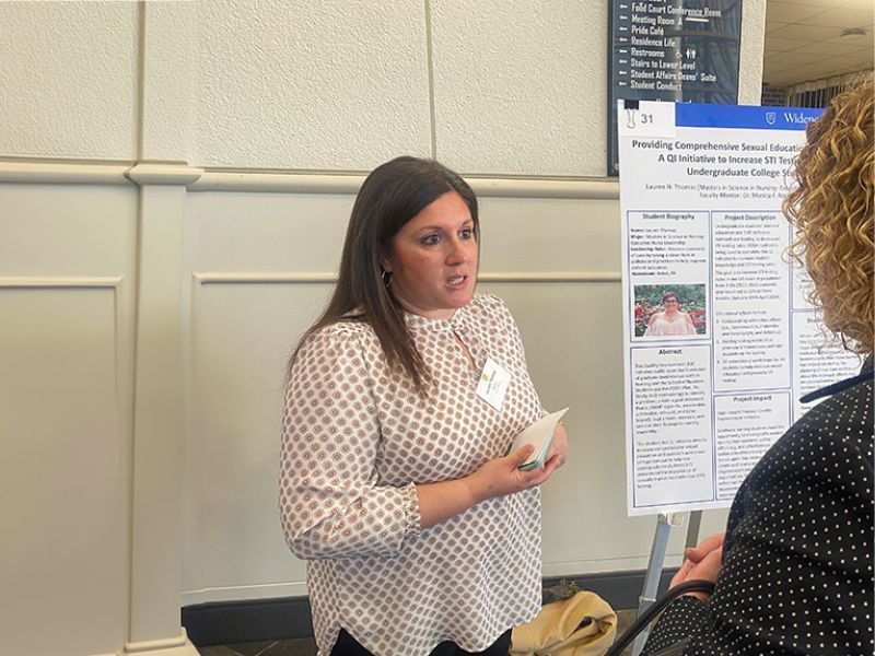 Lauren Thomas presents her research poster.