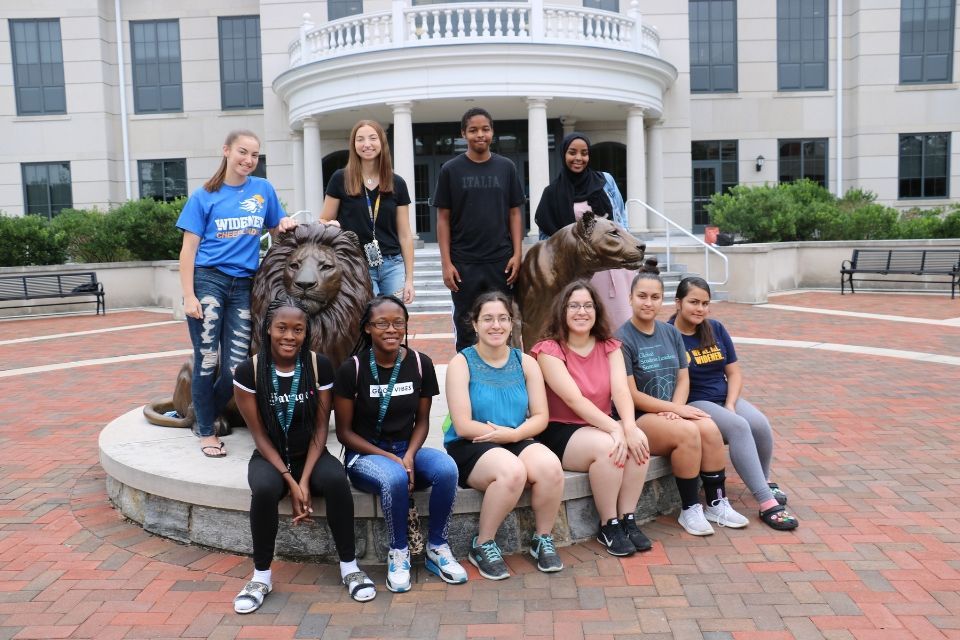 Widener twins in front of Pride statue