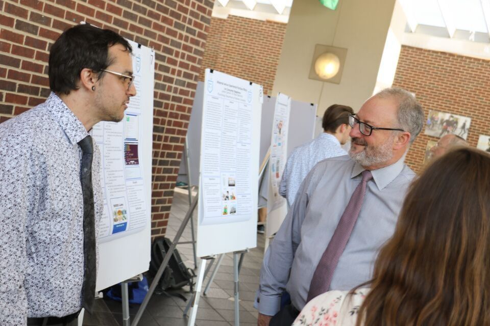 Provost Workman talking with students at an event.