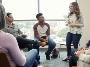 Social Work (MSW) student leading group session 500x375 Social worker leading group session with 4 people present