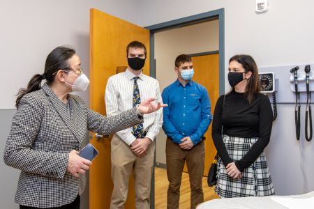 Silvercare Chester 960x640 Doctor talks to three students in medical facility