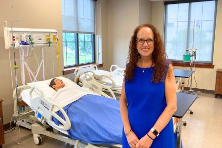 Dean Audrey Snyder poses in a nursing simulation lab.